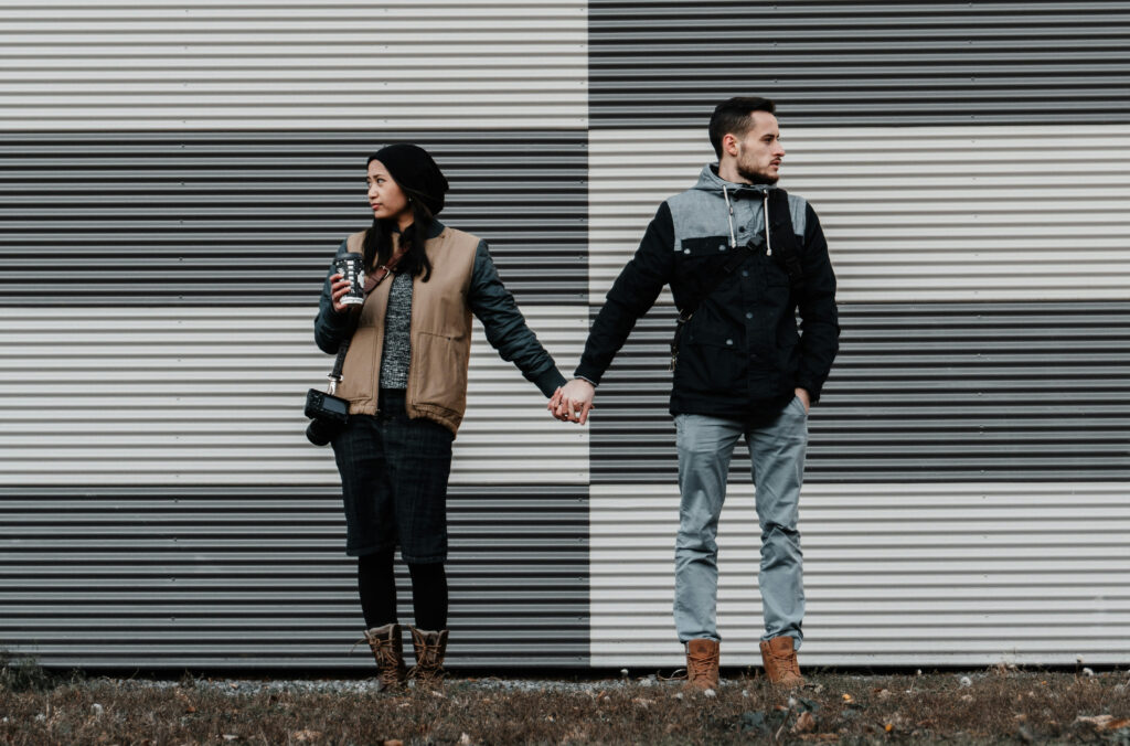 Therapy for relationship issues - couple turned away but holding hands